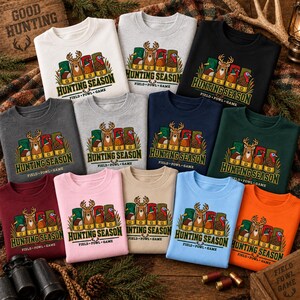 May include: A collection of twelve crewneck sweatshirts in various colors, each featuring a graphic of four shotgun shells with animal illustrations and the text HUNTING SEASON FIELD FOWL GAME printed in a bold, dark green font.