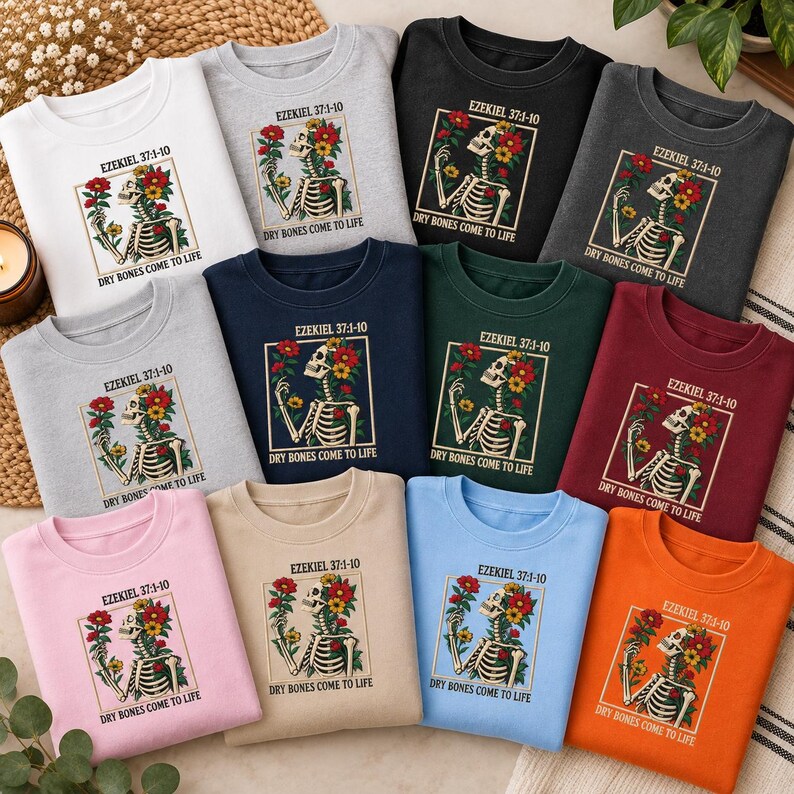 May include: A collection of eleven crewneck sweatshirts in various colors, each featuring a graphic of a skeleton adorned with colorful flowers, the text Ezekiel 37:1-10, and the phrase Dry Bones Come To Life printed in a square frame.