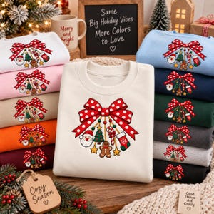 May include: A collection of crewneck sweatshirts in various colors, each featuring a graphic of a large red polka-dot bow with hanging Christmas ornaments including Santa, a tree, a candy cane, a gingerbread man, and a stocking.