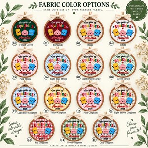 May include: Fifteen circular embroidery hoops featuring fabric color options. Each hoop displays the text The year of squishies, the name Amelia, and the year 2026, accompanied by three cartoon characters in yellow, pink, and blue on various backgrounds.