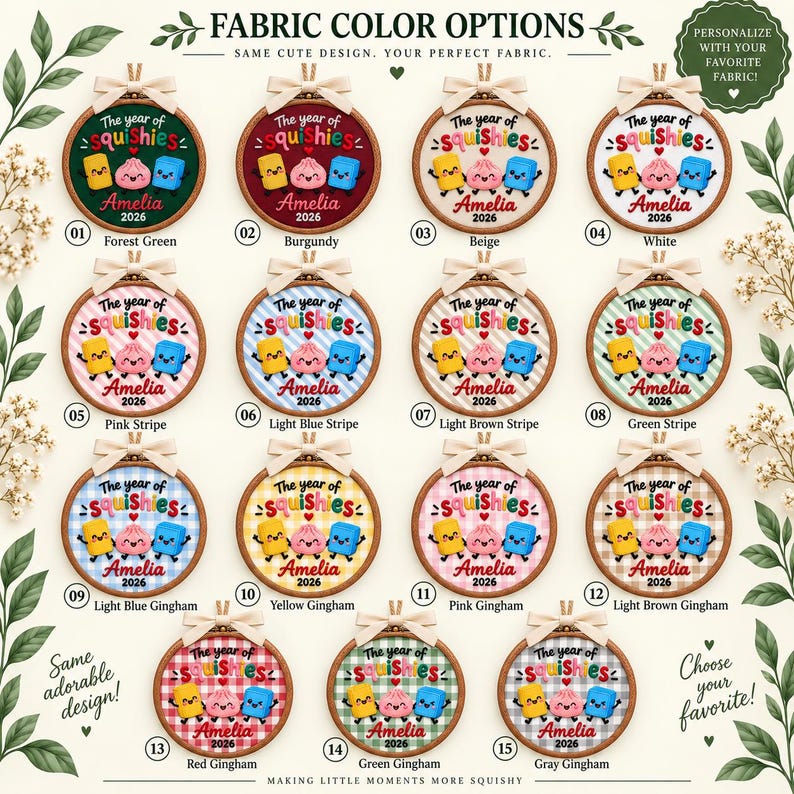 May include: Fifteen circular embroidery hoops featuring fabric color options. Each hoop displays the text The year of squishies, the name Amelia, and the year 2026, accompanied by three cartoon characters in yellow, pink, and blue on various backgrounds.