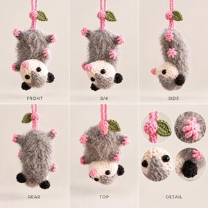 May include: A crocheted opossum hanging ornament featuring a fuzzy gray body, a cream-colored face, black eyes, and pink paws. It hangs from a pink cord with a small green leaf and pink berry accent. The image displays front, side, rear, and top views.