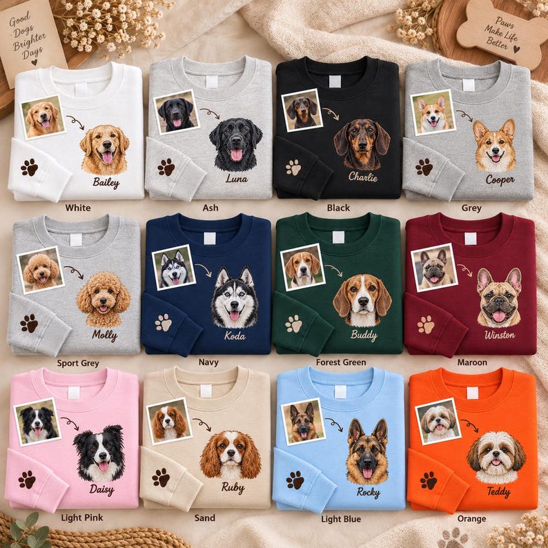 May include: A collection of twelve crewneck sweatshirts in various colours, each featuring a custom dog portrait, a corresponding name, and a paw print on the sleeve. The colours include white, ash, black, grey, sport grey, navy, forest green, maroon, light pink, sand, light blue, and orange.