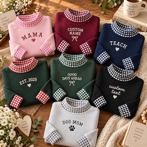 May include: Seven long-sleeved sweatshirts in various colors including pink, maroon, navy, dark green, black, and light gray. Each sweatshirt features a gingham-patterned mock neck collar and cuffs, with embroidered text and icons on the chest.