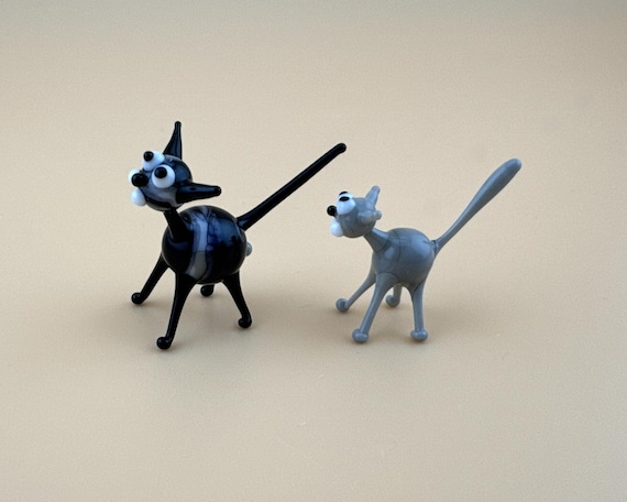 Tiny lampwork glass cats hand-sculpted at the torch — each one is a miniature one-of-a-kind sculpture you didn't know you needed.