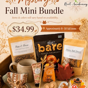 May include: A Mystery Fall Mini Bundle featuring a ceramic mug, a bag of Bun & Brew tea, a bag of Bare baked crunchy snacks, a bag of Autumn Apple Harvest, a tube of shea butter hand cream, a gold leaf spoon, and various fall-themed decor items.