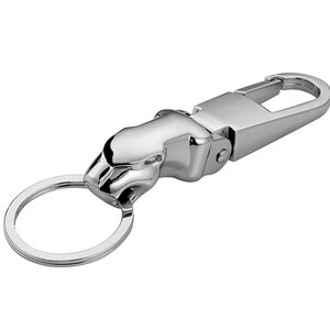 May include: A polished silver-tone metal keychain featuring a stylized jaguar head ornament. The design includes a sturdy spring-loaded lobster clasp mechanism connected to a circular split ring, providing a secure way to organize keys.
