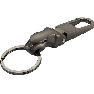 May include: A gunmetal-colored keychain featuring a stylized jaguar head sculpture. The jaguar head is attached to a metal spring-loaded carabiner clip on one side and a circular split ring for keys on the other side, with a smooth metallic finish.