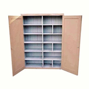 May include: A vintage wooden cabinet with two doors and multiple shelves. The cabinet is painted a light beige color and has a white interior.