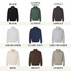 May include: A grid of nine quarter-zip sweatshirts in various colors including black, alpine green, asphalt, ash heather, classic navy, grey heather, bone, brown, and cement. Each sweatshirt features a metal zipper at the collar and long sleeves.