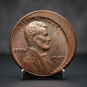 Può includere: Una moneta in rame da 1 centesimo Lincoln del 1909 S che raffigura il profilo di Abraham Lincoln rivolto verso destra. Il testo IN GOD WE TRUST è arcuato in alto, con la parola BERTY visibile a sinistra e la data 1909 S in basso a destra.