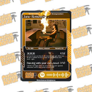 May include: A rectangular trading card featuring a brown and black border with the text Jane Remover at the top. The centre image shows a person sitting in a chair in a room with a large flame above their hands. Text includes song titles JRJRJR and Dancing with your eyes closed, along with a Spotify code at the bottom.