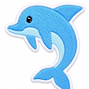 May include: An embroidered iron-on patch shaped like a leaping dolphin. The dolphin features bright blue thread for the main body, a lighter blue belly, and a solid black eye. The entire design is outlined with a thick, white stitched border.