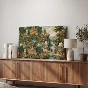 May include: A rectangular wall art print featuring a lush, detailed landscape painting with dense green foliage, white domed pavilions, a winding river, and numerous small figures in colorful traditional attire scattered throughout the scene.