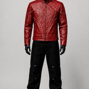 May include: A red leather jacket featuring a raised spider web design on the chest and white piping details, paired with black trousers that have silver metal rivets along the legs and black boots, displayed on a full-body mannequin.