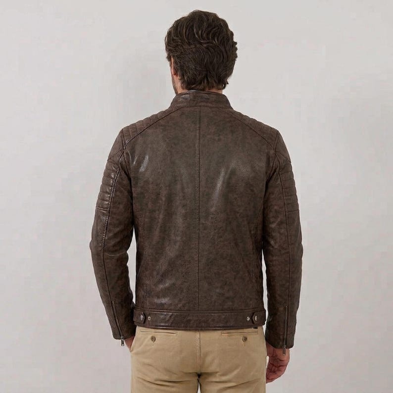 Men's brown leather jacket with quilted shoulder details and zipper pockets