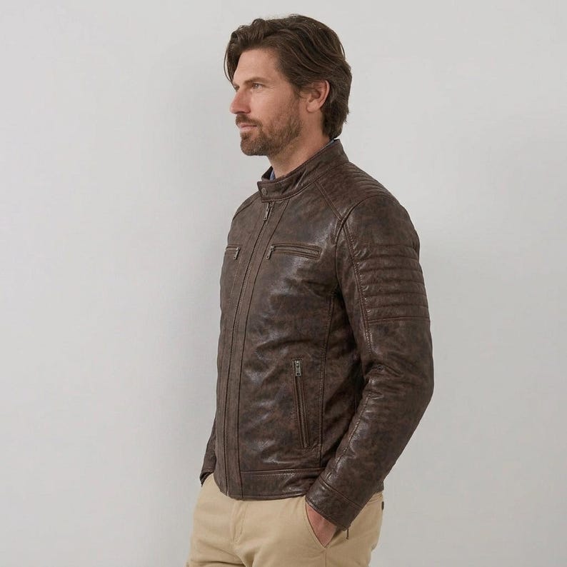 Men's brown leather jacket with quilted shoulder details and zipper pockets