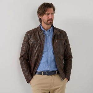 Men's brown leather jacket with quilted shoulder details and zipper pockets