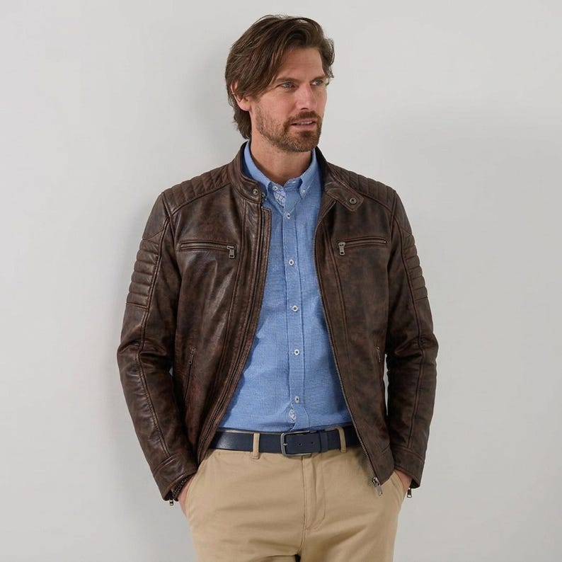 Men's brown leather jacket with quilted shoulder details and zipper pockets