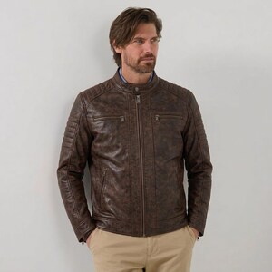 Men's brown leather jacket with quilted shoulder details and zipper pockets