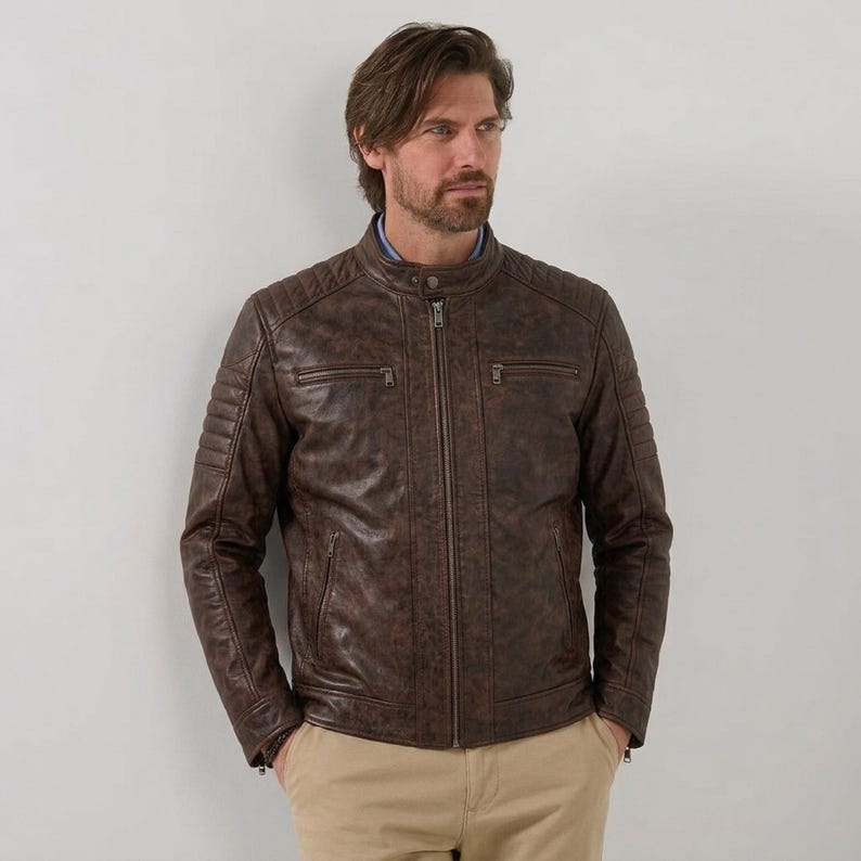 Men's brown leather jacket with quilted shoulder details and zipper pockets