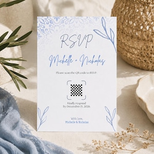 Puede incluir: Una tarjeta RSVP rectangular blanca con arte lineal floral azul, un borde estilo mandala en la parte superior y el texto RSVP, Michelle + Nicholas, Please scan the QR code to RSVP, Kindly respond by December 15, 2026, y With love, Michelle & Nicholas.