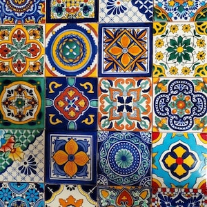 May include: A collection of twenty square ceramic tiles arranged in a grid, each featuring distinct, colorful hand-painted patterns in shades of blue, yellow, orange, green, and red, showcasing intricate geometric, floral, and symmetrical motifs.