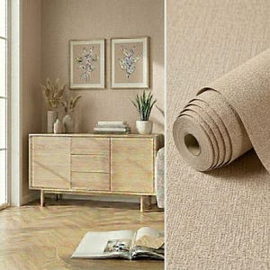 May include: A roll of beige wallpaper with a textured, fabric-like finish. The surface features a subtle cross-hatch pattern that mimics the appearance of woven linen. The material is shown partially unrolled, revealing the thickness and texture.