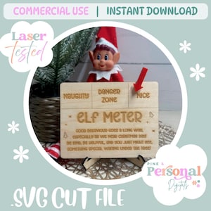 May include: A rectangular wooden sign labeled ELF METER with three sections marked NAUGHTY, DANGER ZONE, and NICE. A red arrow points to the NICE section. The sign includes engraved text about Christmas behavior and is supported by a small stand.