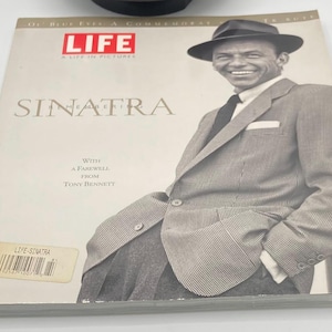 May include: A Life magazine commemorative issue titled Sinatra: A Life in Pictures, featuring a black and white photograph of Frank Sinatra wearing a fedora and a patterned suit jacket. The cover includes text with a farewell from Tony Bennett.