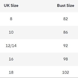May include: A size chart table with black text on a white background. Columns are labeled Size, UK Size, Bust Size, and Skirt Length. Rows list sizes S, M, L, XL, and XXL with corresponding numerical values for UK size, bust size, and skirt length measurements.