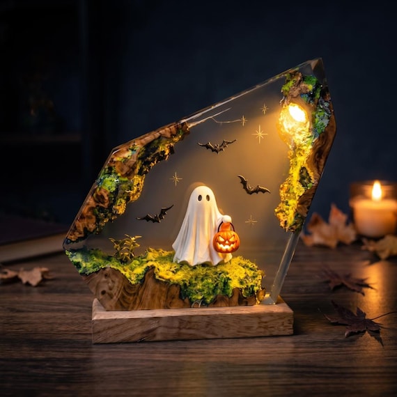 A spooky ghost-and-pumpkin scene encased in glowing epoxy resin — Halloween decor that actually looks like art, not Party City.