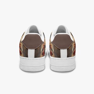 May include: A pair of low-top sneakers featuring a white sole and a brown heel tab. The sides of the shoes display a graphic illustration of a character wearing a red coat and dark clothing, set against a muted, textured background.