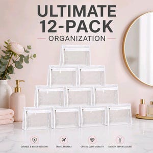 May include: A set of twelve clear rectangular storage pouches with white zippers, arranged in a pyramid stack. The text ULTIMATE 12-PACK ORGANIZATION is displayed above, with icons and labels for durable, water-resistant, travel-friendly, and zipper features.
