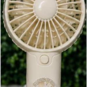 May include: A cream-colored handheld fan with a circular fan head and a cylindrical handle. The fan head has multiple blades. The handle features a button and a circular image of a person with text. The fan is on a white surface.