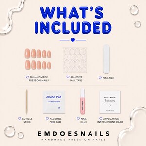 May include: A press-on nail kit labeled WHAT'S INCLUDED containing 10 nude press-on nails, a sheet of adhesive nail tabs, a white nail file, a wooden cuticle stick, an alcohol prep pad, a tube of nail glue, and an application instructions card.