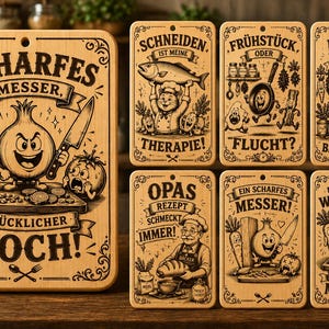 May include: A collection of seven rectangular wooden cutting boards featuring engraved illustrations and German text. The designs include cartoon vegetables, a chef, and kitchen-themed phrases like SCHARFES MESSER, GLÜCKLICHER KOCH.