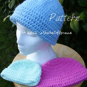 May include: Two crocheted hats, one light blue and one pink. The hats are made with a textured stitch and have a simple, classic design.