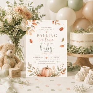 May include: A rectangular baby shower invitation card featuring watercolour autumn leaves and a pumpkin at the bottom. The text reads: PLEASE JOIN US FOR A BABY SHOWER FALLING in love WITH baby HONORING Ashley Ruth SATURDAY OCTOBER 25, 2027 2:00 PM THE SMITH RESIDENCE 123 AUTUMN LANE ANYTOWN, ST 12345 RSVP TO EMILY AT 555-123-4567 REGISTERED AT AMAZON & TARGET.