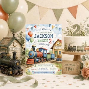 May include: A birthday invitation card featuring a watercolor illustration of a steam train, a station building, and balloons. The text reads: ALL ABOARD! IT'S TIME TO CELEBRATE JACKSON IS TURNING 2 CHOO CHOO! SATURDAY, JUNE 14, 2027, 2:00 PM, 123 TRACKSIDE WAY, SAN ANTONIO, TX 78236, RSVP TO AMY 210-555-1234, GET YOUR TICKETS FOR A MAGICAL RIDE!