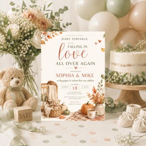 May include: A rectangular baby sprinkle invitation card featuring autumn leaves, a wicker basket with a teddy bear, a pumpkin, and a mug. The text reads: PLEASE JOIN US FOR A BABY SPRINKLE WE'RE FALLING IN love ALL OVER AGAIN HONORING SOPHIA & MIKE.