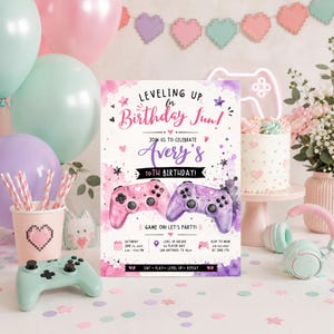 May include: A rectangular birthday invitation card featuring a pink and purple watercolour background with two video game controllers, stars, and hearts. The text reads Leveling Up for Birthday Fun, Avery's 10th Birthday, and Game On! Let's Party, with event details including date, time, location, and RSVP information.