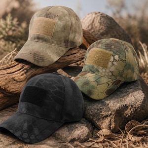 May include: Three baseball caps featuring a rectangular hook-and-loop patch on the front. One cap is in a muted olive green, one features a multi-colored camouflage pattern, and the third is in a dark black camouflage pattern with a black patch.