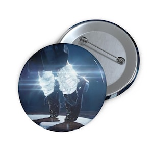 May include: A circular pin-back button featuring a graphic of black dress shoes paired with white sequined socks. The image shows a close-up of the feet in a dance pose with bright lens flare light effects against a dark blue background.