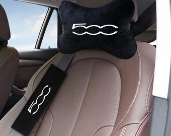 May include: A black velvet car headrest pillow and a matching black seat belt shoulder pad, both featuring the white 500 logo. The pillow is shaped like a bone and is attached to the headrest, while the rectangular pad covers the seat belt.