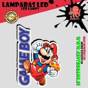 May include: A graphic design featuring the text GAME BOY in blue letters next to a colorful illustration of Mario jumping and holding a yellow mushroom. The image includes a best seller badge, a pink octopus logo, and the text MAS DISE&Ntilde;OS EN WWW.CENTROGAME.ES.