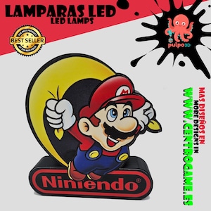 May include: A decorative LED lamp featuring a colorful graphic of Mario jumping in front of a large yellow circle. The lamp base is black with a red oval containing the text Nintendo. The design includes a best seller badge and an octopus logo.