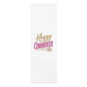May include: A white rectangular yoga mat featuring the gold glitter text Heyyy and the pink glitter text COWORKER. Below the text is a small graphic of a coffee cup with a pink heart and steam, accompanied by two tiny pink hearts on a white background.