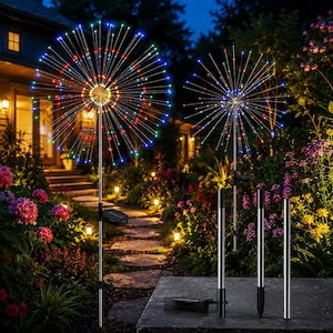 May include: Two solar-powered garden lights featuring spherical firework-like designs with multi-colored LED wire branches. The lights are mounted on thin metal stakes with small solar panels attached. Additional stakes are shown in the foreground.