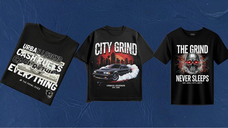 May include: Three black short-sleeve t-shirts. The left shirt features text reading URBAN LEGEND CASH RULES EVERYTHING and a 100 dollar bill graphic. The center shirt shows a car with the text CITY GRIND. The right shirt displays a skull with red eyes.